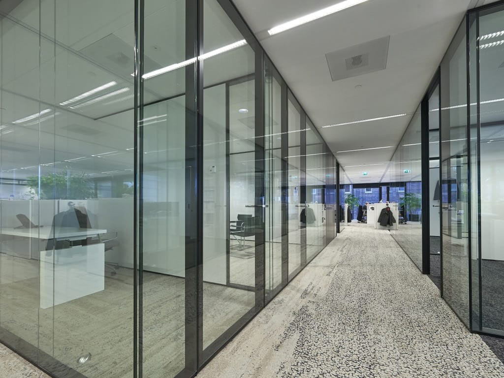 Glass walls to separate workspaces corridor view