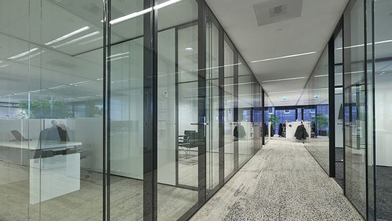 Glass walls to separate workspaces corridor view