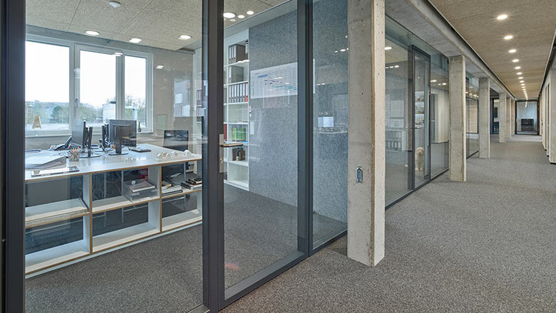 Glass walls to separate workspaces corridor view
